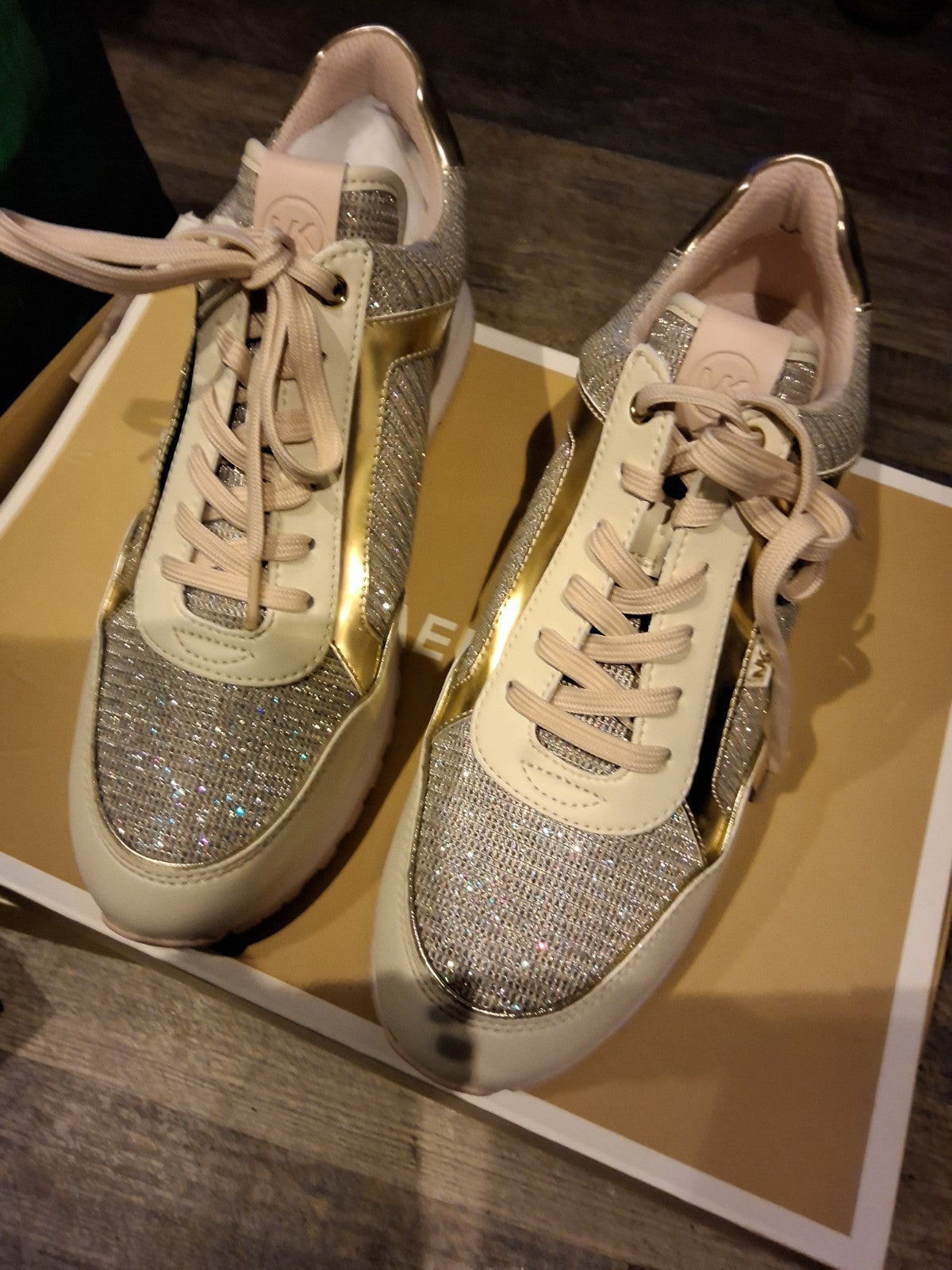 These Michael Kors sneakers are a shimmering highlight, featuring a stylish mix