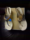 Michael Kors Roxane Wedge Sandals In A Pale Gold Metallic Finish Featuring Logo