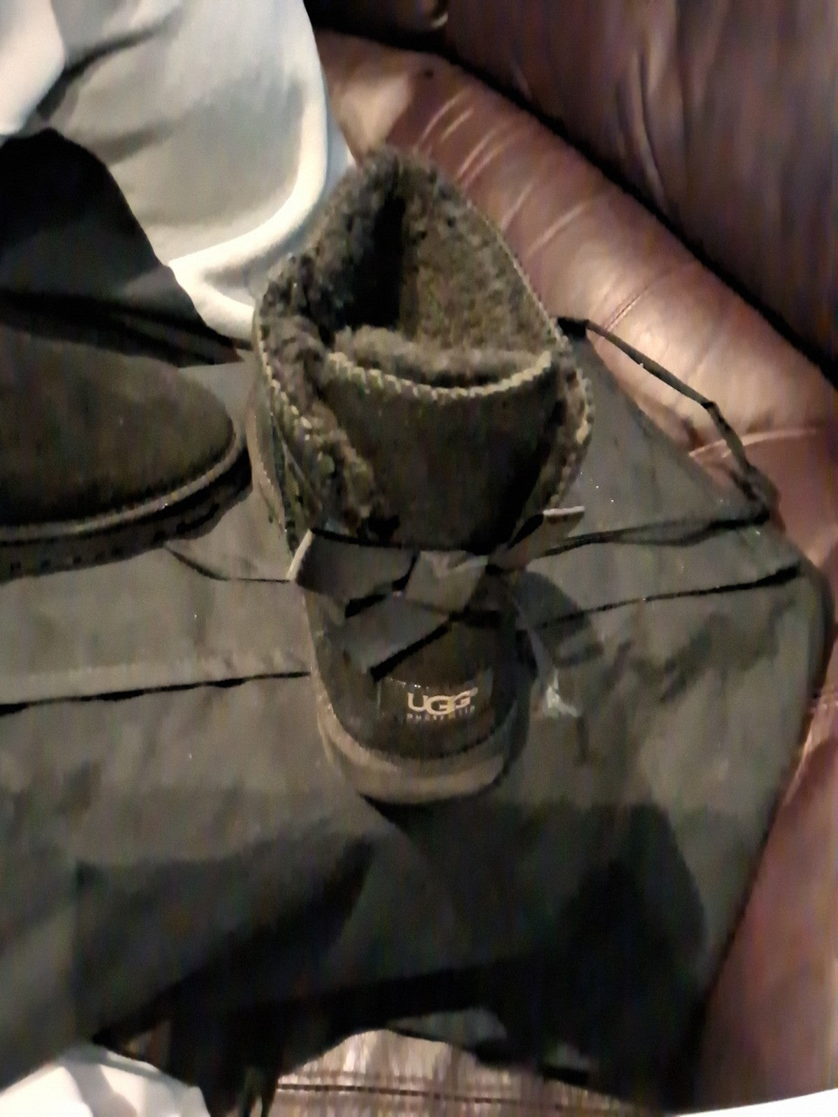 These black UGG Bailey Bow II boots feature a suede upper and a fixed satin bow