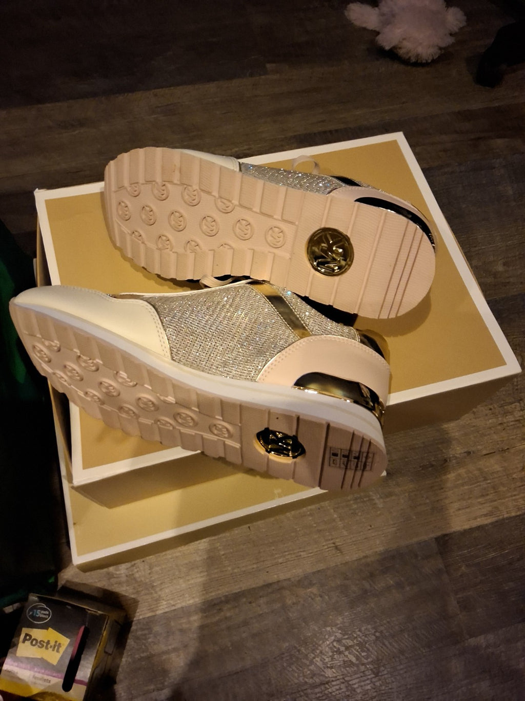 These Michael Kors sneakers are a shimmering highlight, featuring a stylish mix