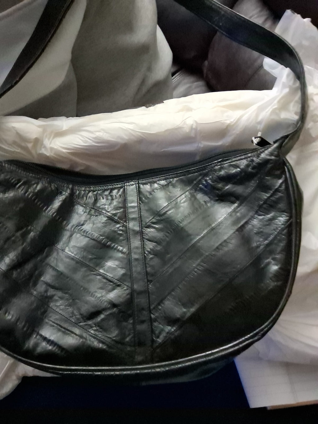 This item is a vintage black genuine eel skin hobo shoulder bag