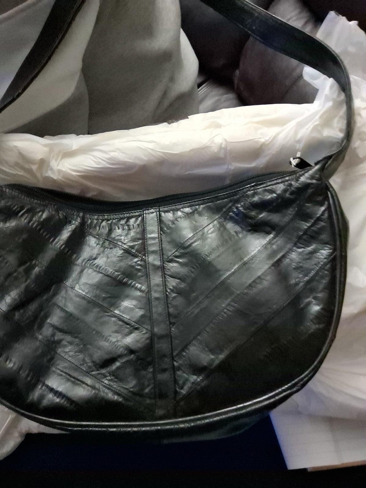 This item is a vintage black genuine eel skin hobo shoulder bag
