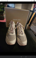 These Michael Kors sneakers are a shimmering highlight, featuring a stylish mix